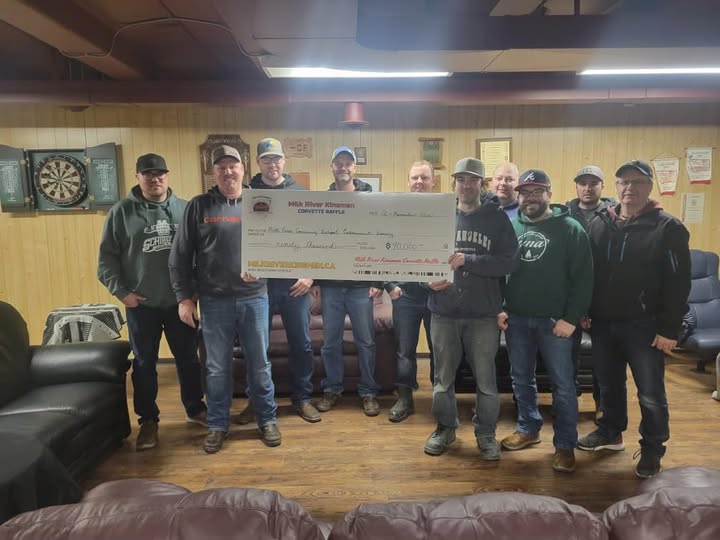Milk River Kinsmen volunteers present a novelty cheque from the Corvette Raffle