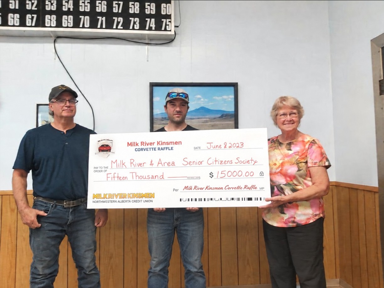 Milk River Kinsmen volunteers present a novelty cheque from the Corvette Raffle to the Milk River & Area Senior Citizens Society